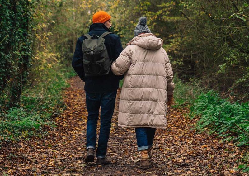 couple going for an autumn walk in the woods